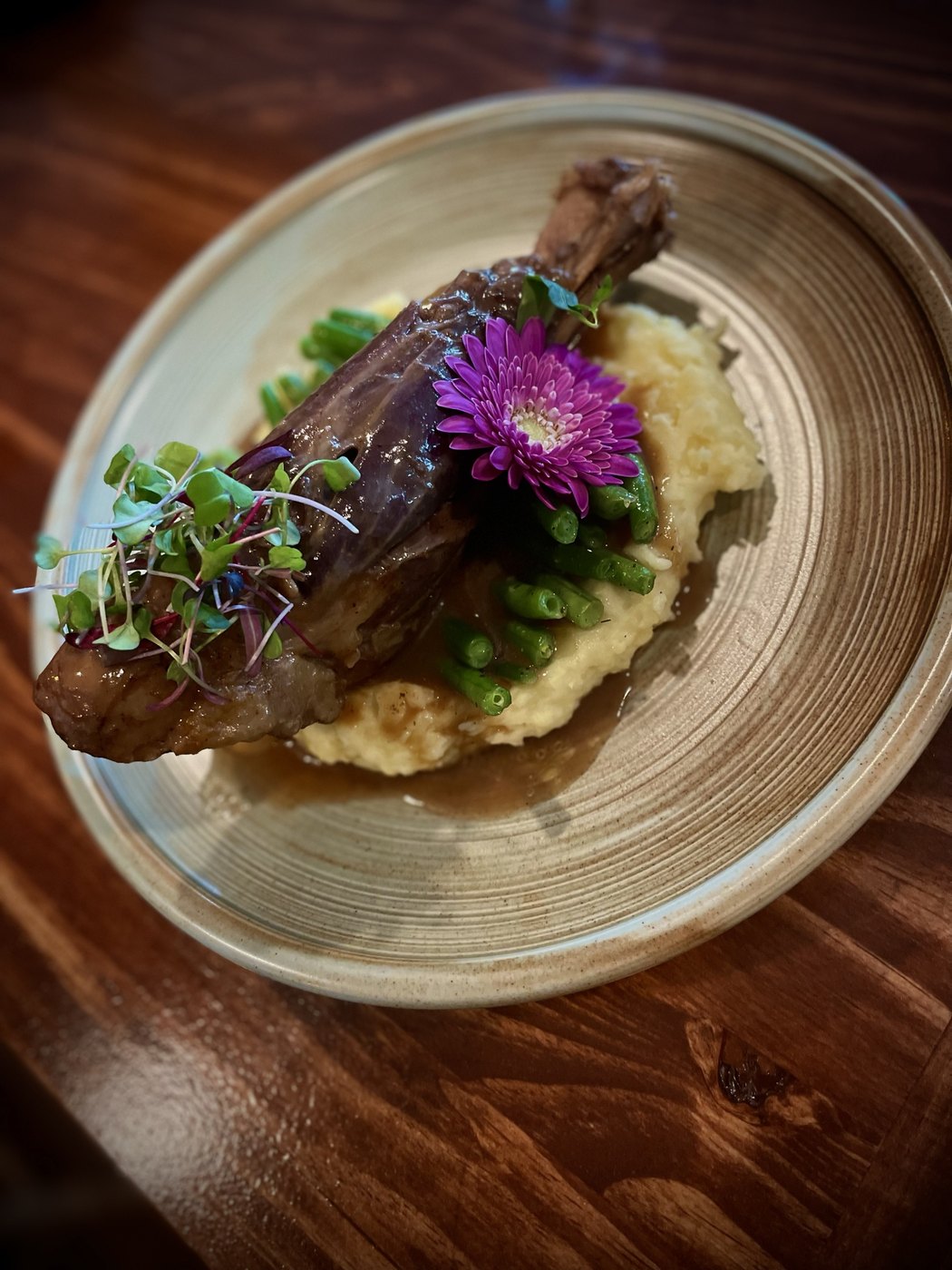 Roasted lamb shank with mashed potatoes and green beans