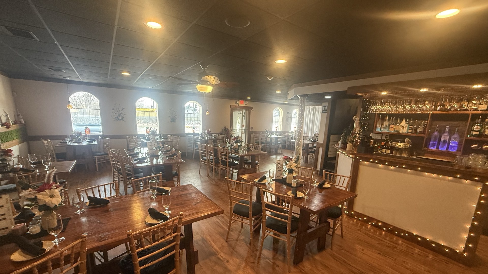 Nad Tatrami dining room in Monee, Illinois with wood tables, arched windows and the full bar