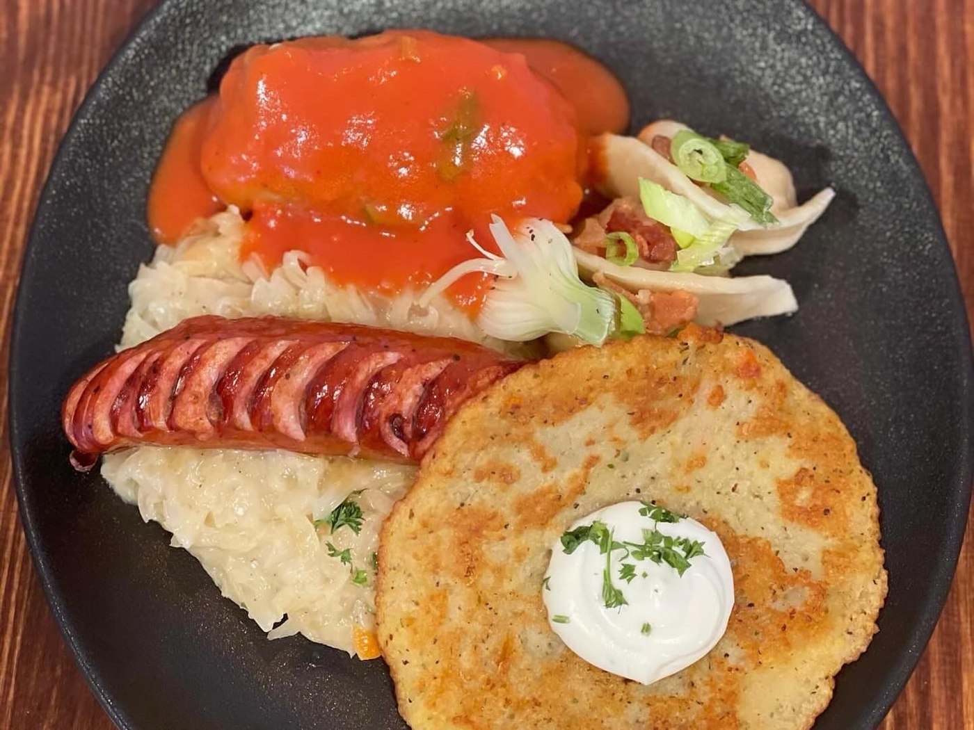 Polish Plate Nad Tatrami with stuffed cabbage, sauerkraut, Polish sausage, potato pancake and sour cream